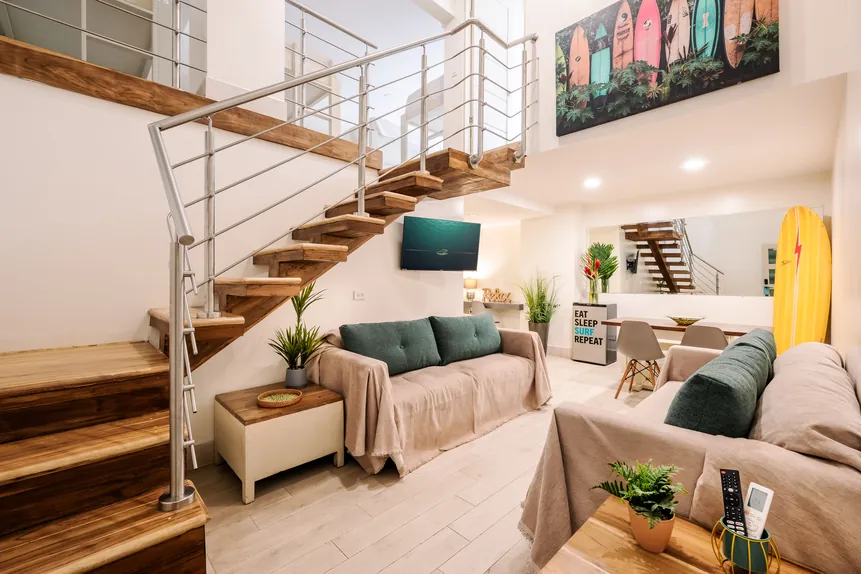 Private Bunkhouse Suite living area with loft staircase