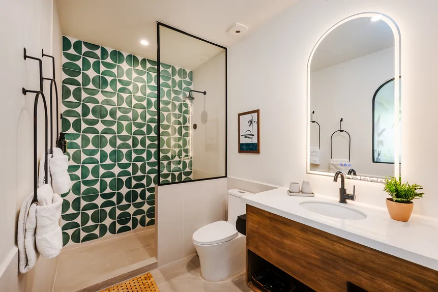 En-suite bathroom with green tile shower
