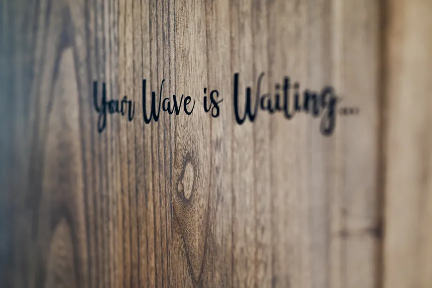 Your Wave is Waiting wood sign at Iguana Surf