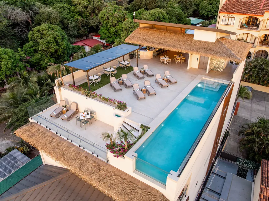Aerial view of the rooftop pool, sun deck and bar at Iguana Surf
