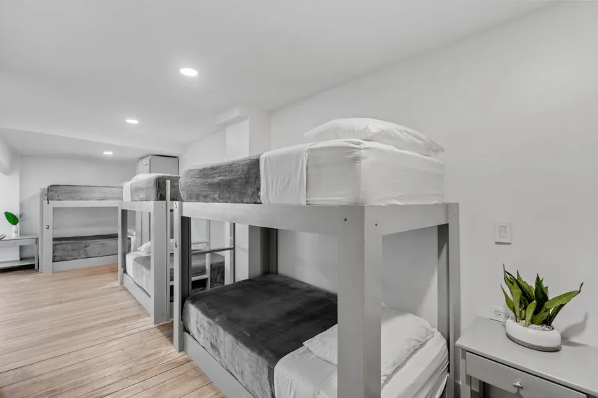 Row of bunk beds in the Shared Surf Dorm